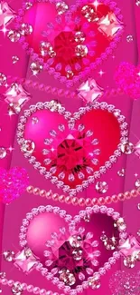 Pink gemstone hearts with jewelry accents on wallpaper background.