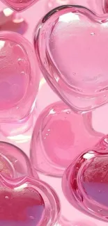 Translucent pink heart glass beads clustered together.