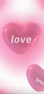 Pink heart with love text on mobile wallpaper.