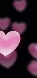 Glowing pink hearts on a dark background, perfect for a romantic mobile wallpaper.