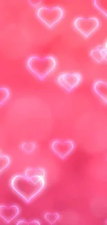 Pink neon hearts wallpaper with glowing effect.