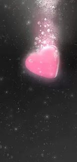 Pink heart on a black background mobile wallpaper.