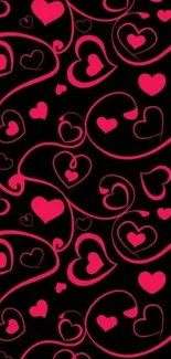 Mobile wallpaper with pink heart patterns on black background.