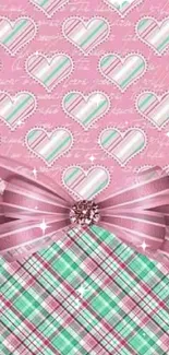 Pink heart pattern wallpaper with ribbon and plaid design.