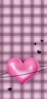 A pink heart on a plaid background wallpaper.