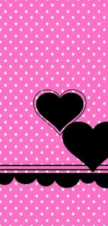 Pink polka dot wallpaper with black hearts.