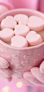 Warm pink mug with heart marshmallows.