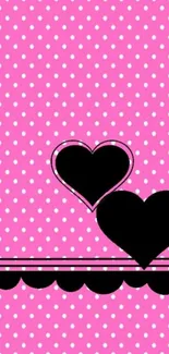 Pink polka dot wallpaper with black hearts design.