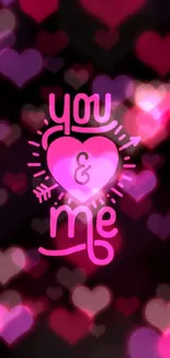 Black wallpaper with pink heart saying 'you & me' symbolizing love.