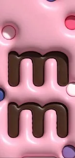 Pink mobile wallpaper featuring colorful M&M chocolates.