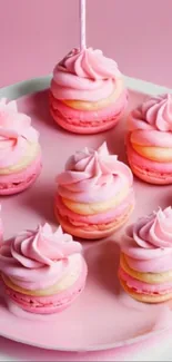 Pink macarons with creamy swirls on a tray.