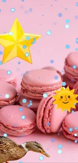 Pink macarons with a duck and playful icons on a vibrant background.