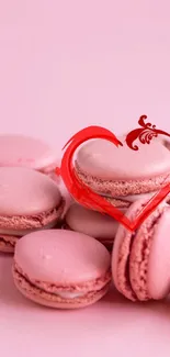 Pink macarons with red heart design mobile wallpaper.