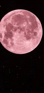 Pink full moon against a black starry sky.