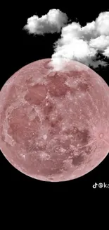 Pink moon with white clouds on a black background.