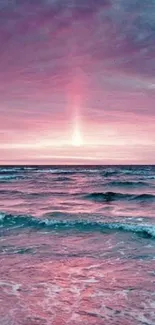 Pink ocean sunset with waves under a vibrant sky.