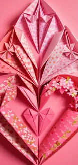 Pink origami art with floral patterns on a vibrant wallpaper.