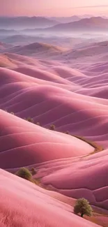 Serene pink rolling hills at dawn with misty backdrop.