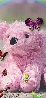 Pink plush toy with butterflies and a rainbow.