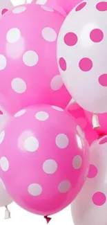 Pink polka dot balloons create a vibrant and playful wallpaper.