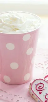 Pink mug with polka dots and heart cookie.