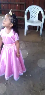 Young girl in pink princess dress with bokeh effect.