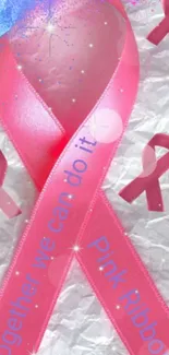 Pink ribbon on textured background symbolizing cancer awareness.