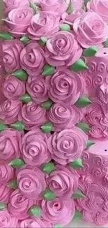 Heart-shaped pink cake with rose decorations.