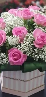 Bouquet of pink roses in a decorative box.