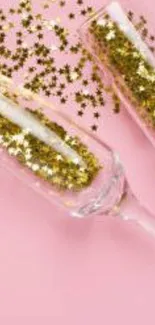 Champagne glasses with gold stars on a pink background.