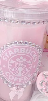 Elegant pink Starbucks cup with jewel decorations.