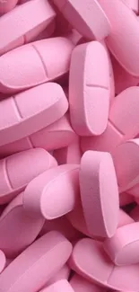 Pink tablets creatively arranged for a colorful mobile wallpaper.