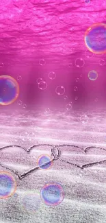 Pink underwater scene with hearts in sand and bubbles.