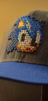 Pixel art blue cap with character design.