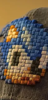 Pixelated blue hat design on fabric wallpaper.