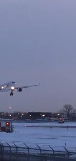 Airplane landing at snowy airport during dusk with blue-gray sky.