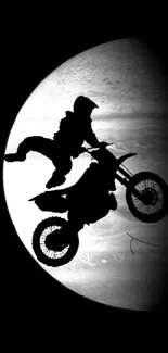 Motocross bike silhouette passing planets against a black space background with the sun.