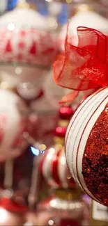 Close-up of red glittery Christmas ornaments with ribbon detailing.