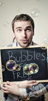 Man holding chalkboard with bubbles around.