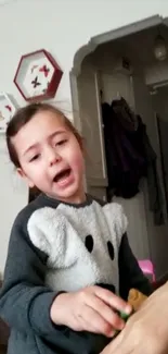 Girl playing indoors in casual home setting.