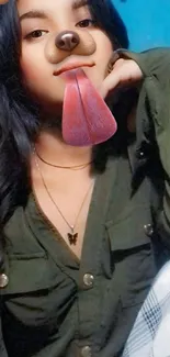 Woman's selfie with playful dog filter on blue background.