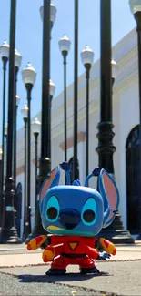 Blue cartoon figurine in urban setting with street lamps.