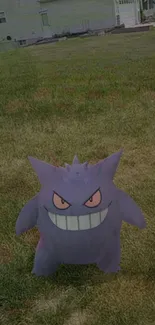 Gengar with a mischievous grin on grass background.