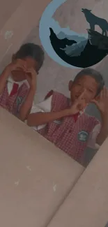 Children in uniforms posing with a wolf-themed phone wallpaper.