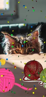 Playful kitten peeks with colorful yarn balls and confetti in vibrant scene.