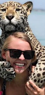 Woman in sunglasses with leopard in ocean