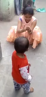 Child taking first steps outdoors in a colorful courtyard.