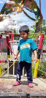 Child on a colorful playground bridge with greenery in the background.