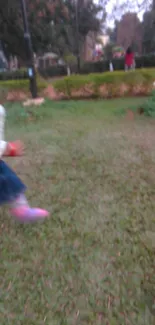 Toddler running through a green garden with vivid colors.