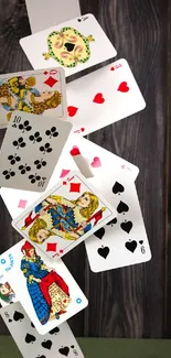 Artistic cascade of vintage playing cards on a dark wooden background.